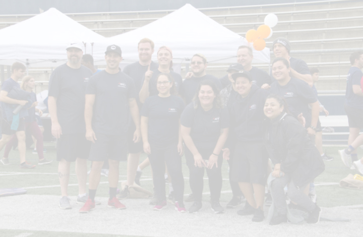 Group photo of a team at an outdoor event.