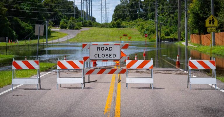'Road Closed' sign on flooded roadway | ATI Restoration
