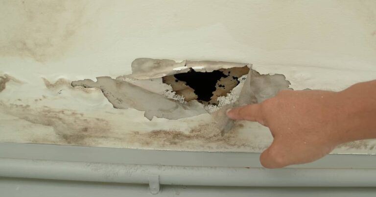 Man pointing out water damage to a property | ATI Restoration