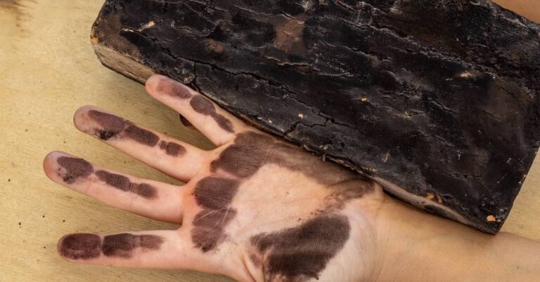 Man with soot on his hand from fire-damaged contents | ATI Restoration