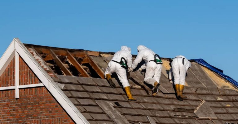 Professional technicians performing home asbestos removal in full PPE | ATI Restoration